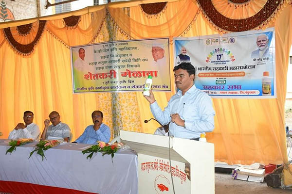 A speaker addressing participants at a Krushi Mela