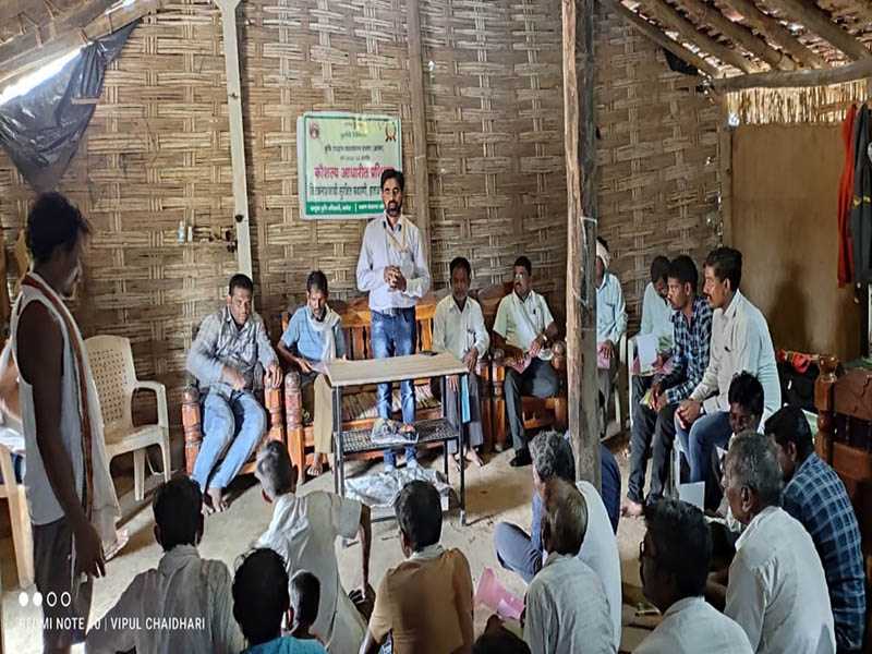 A college representative leading a village workshop with farmers